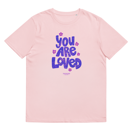 Pink organic t-shirt with 'YOU ARE LOVED' text and daisy graphics, on a white background