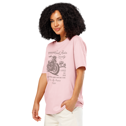 Woman wearing pink organic t-shirt with motorcycle graphic and text 'Soul rider society, ride with intention, make every mile count' on a white background
