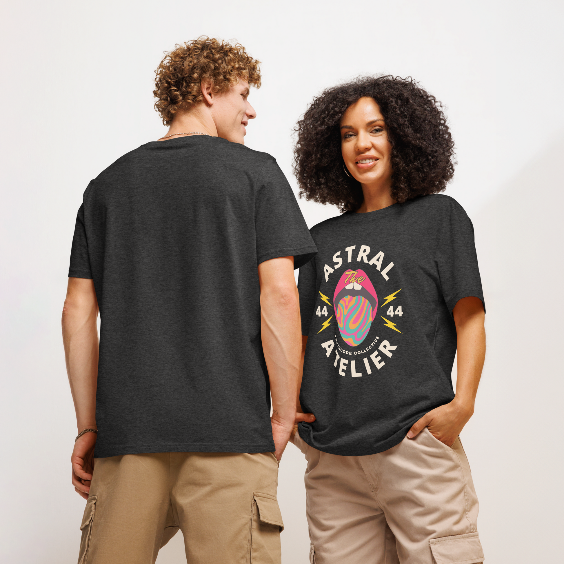 Models wearing black organic t-shirts with a colorful graphic design and text 'Astral Atelier' on a plain background