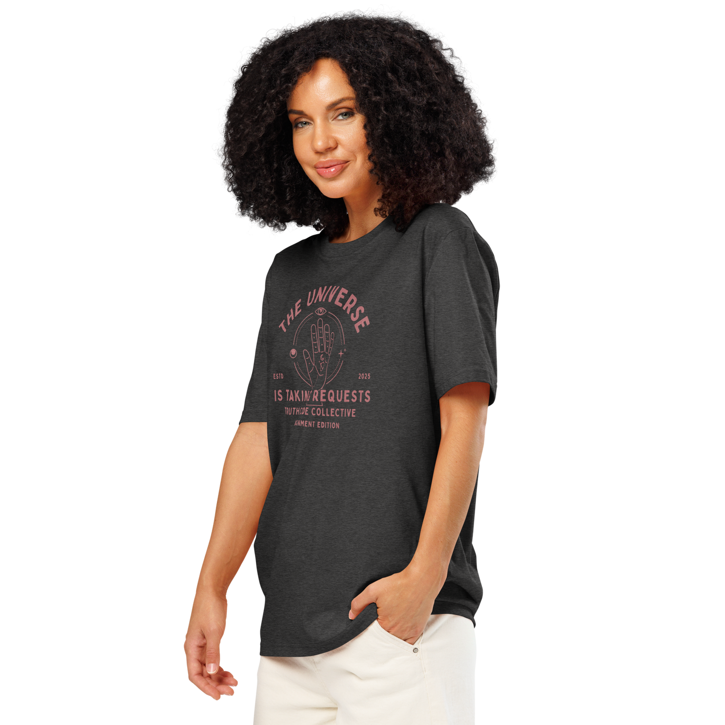 Woman wearing dark gray organic t- shirt with astrological style graphic of a hand with text reading ' The universe is taking requests'