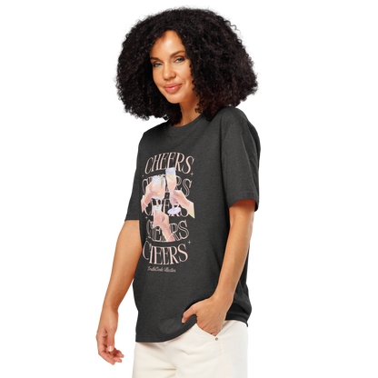Woman wearing dark gray organic t-shirt with 'Cheers' text and graphic design of hands clinking glasses on a white background
