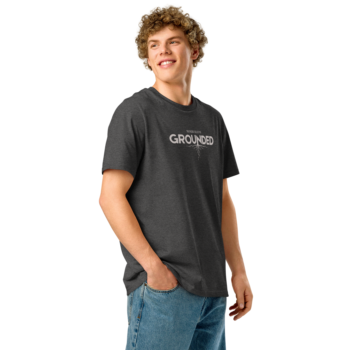 Man wearing gray organic t-shirt with 'GROUNDED' text and tree root graphic extending down