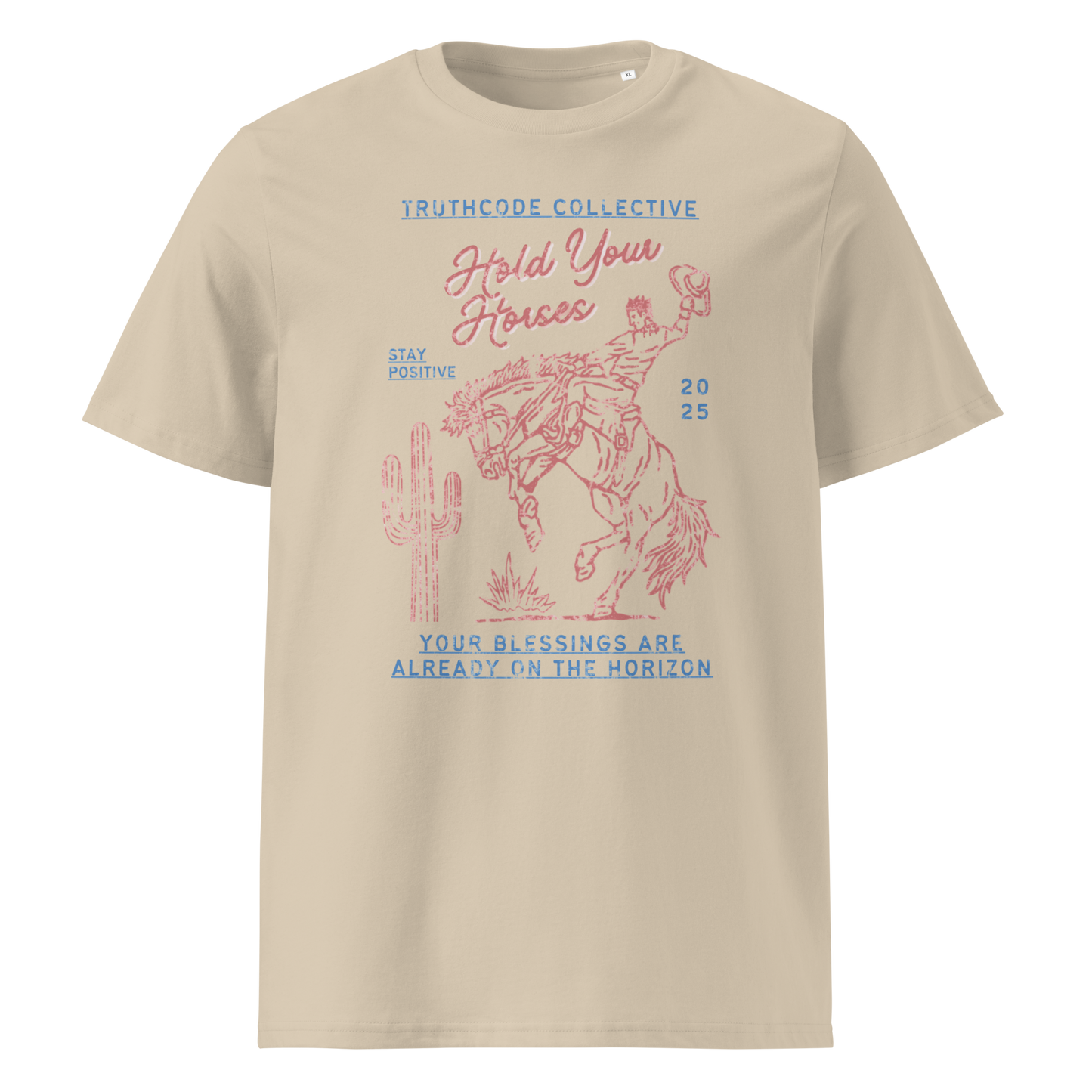Beige organic t- shirt with a western style graphic of a cowboy on a bucking bronco, with the text 'Hold your horses, your blessings are already on the horizon'