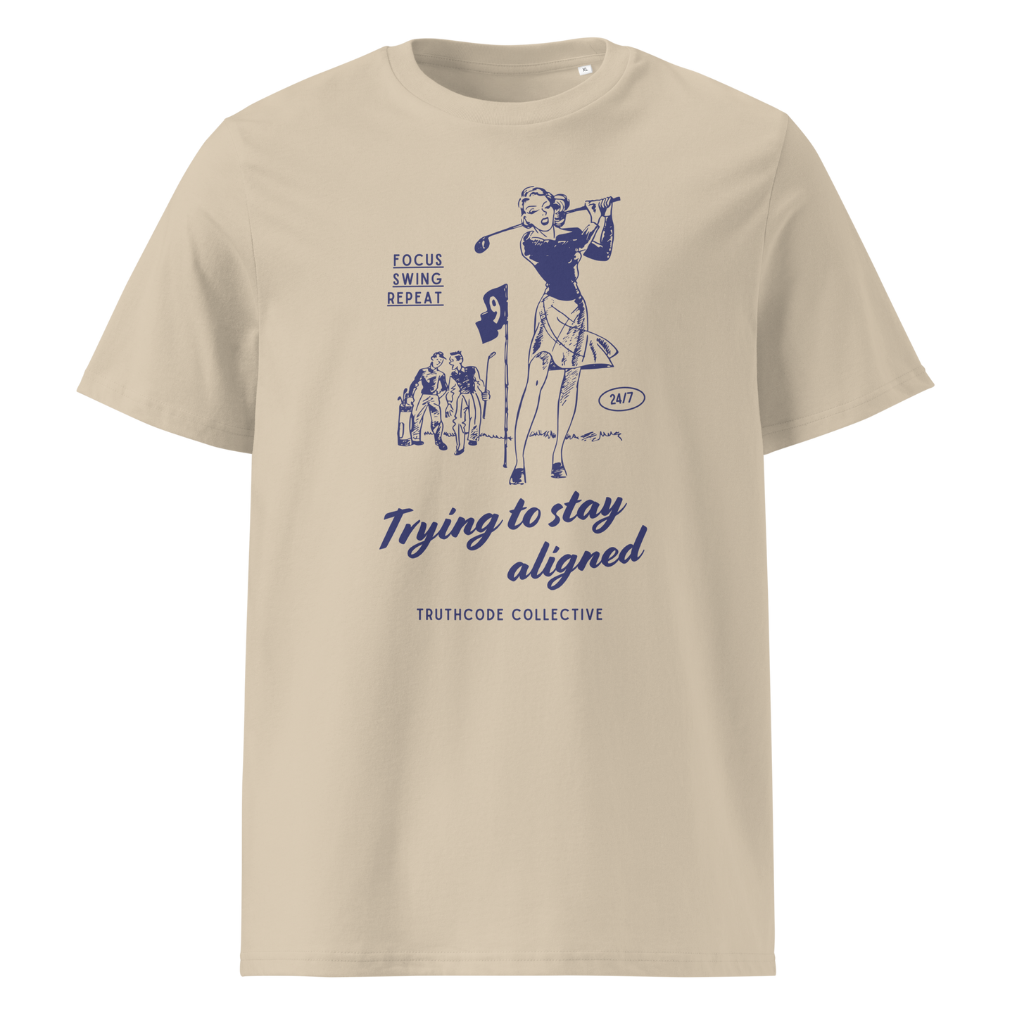 Beige organic t-shirt with blue vintage graphic of a woman golfing and text 'Trying to stay aligned' and 'Focus, swing, repeat' on a white background