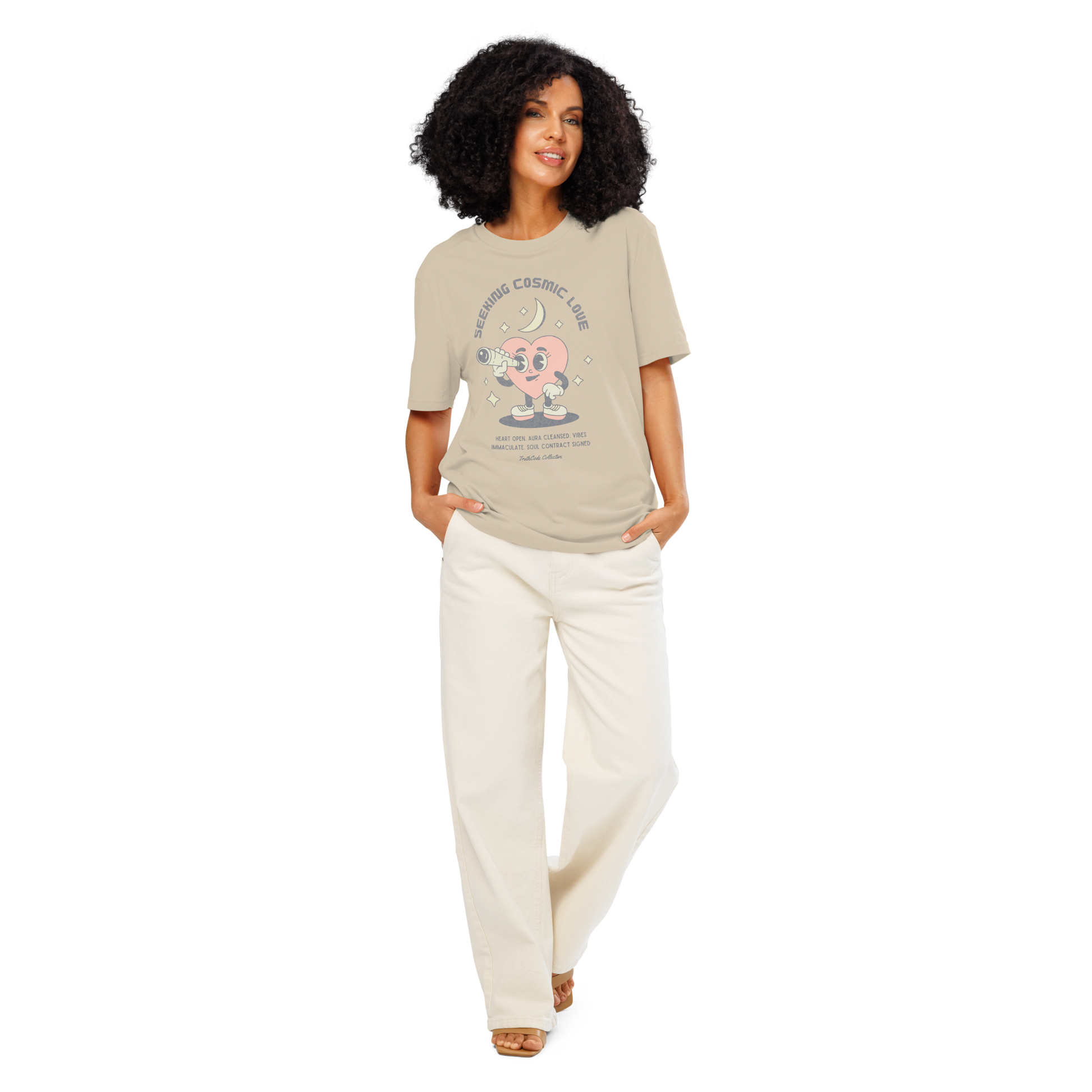 Women wearing beige organic t-shirt with a heart-shaped character holding a telescope and text 'Seeking Cosmic Love' on a white background.
