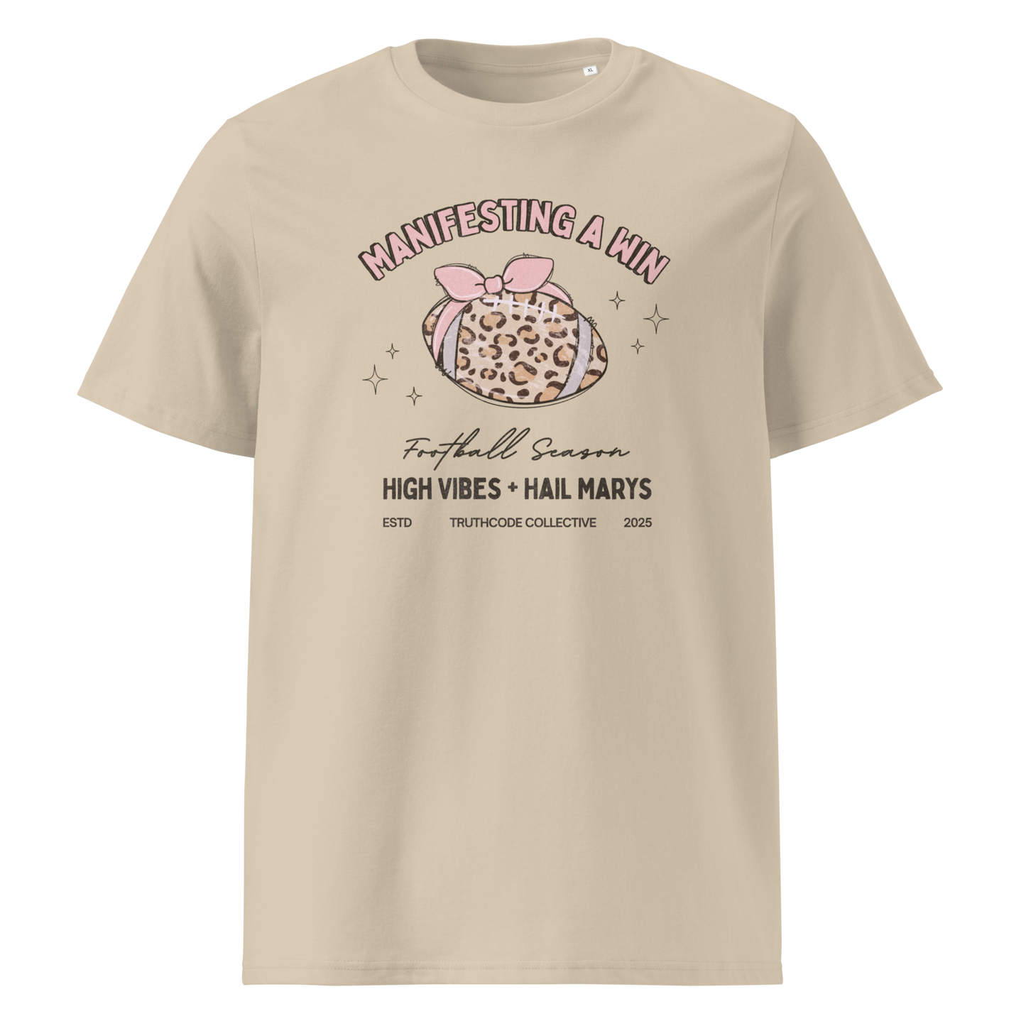 Beige organic t-shirt with girly football graphic and text 'Manifesting a win' and 'Football season, high vibes and hail marys' on a white background