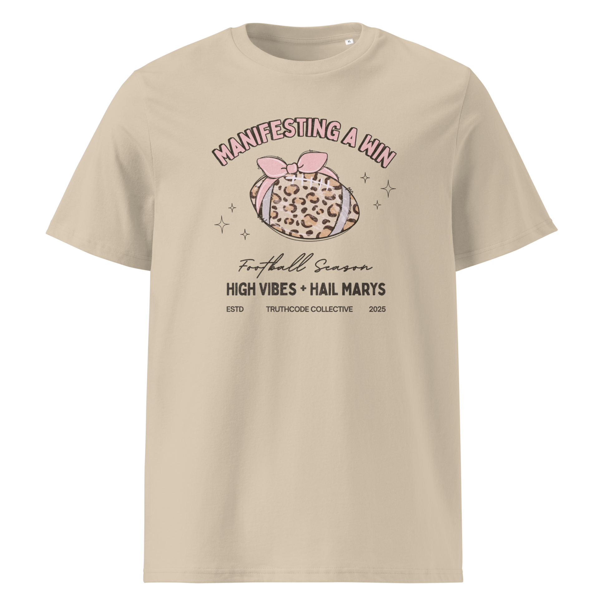 Beige organic t-shirt with girly football graphic and text 'Manifesting a win' and 'Football season, high vibes and hail marys' on a white background
