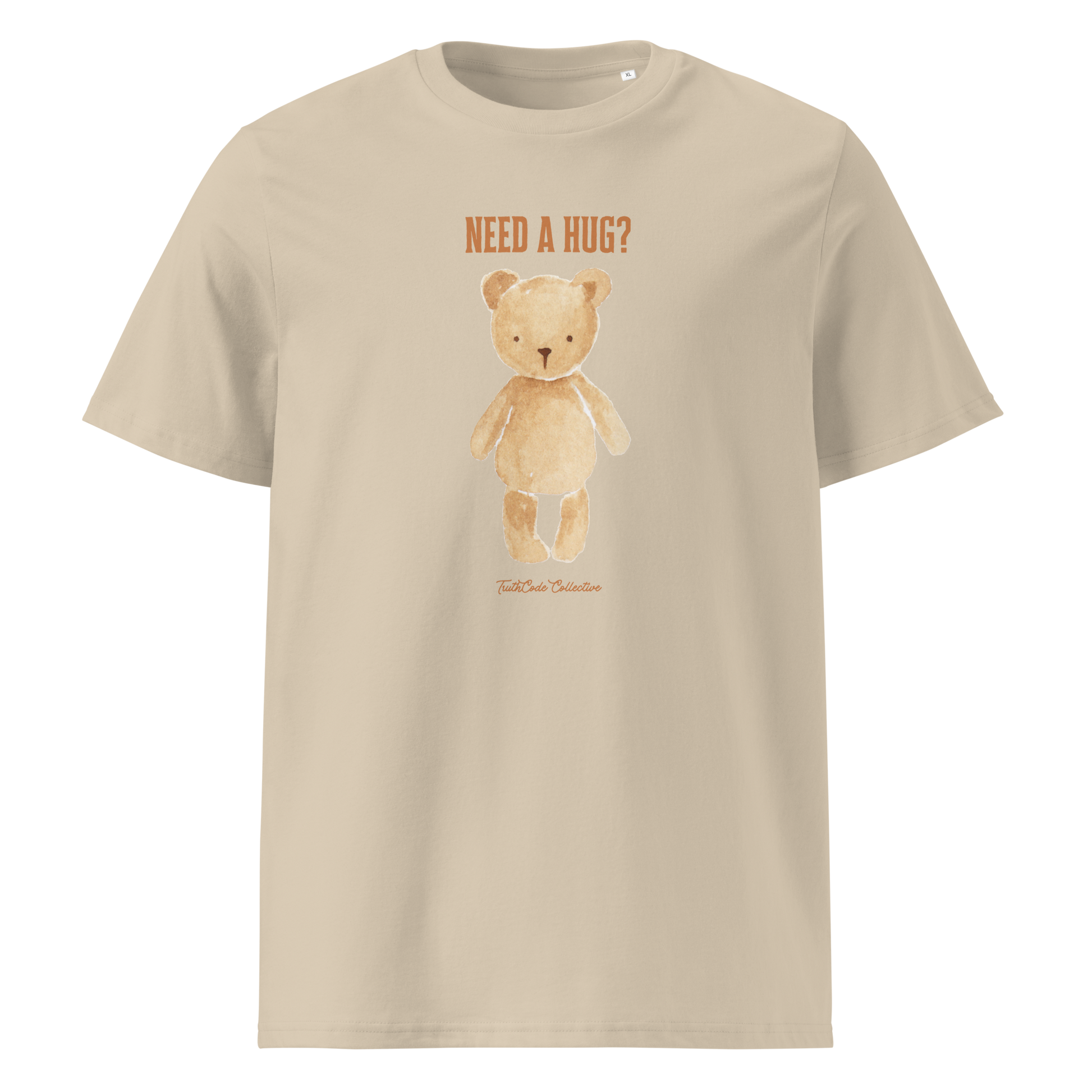 Beige organic t-shirt with a teddy bear graphic and text 'NEED A HUG?' on a white background