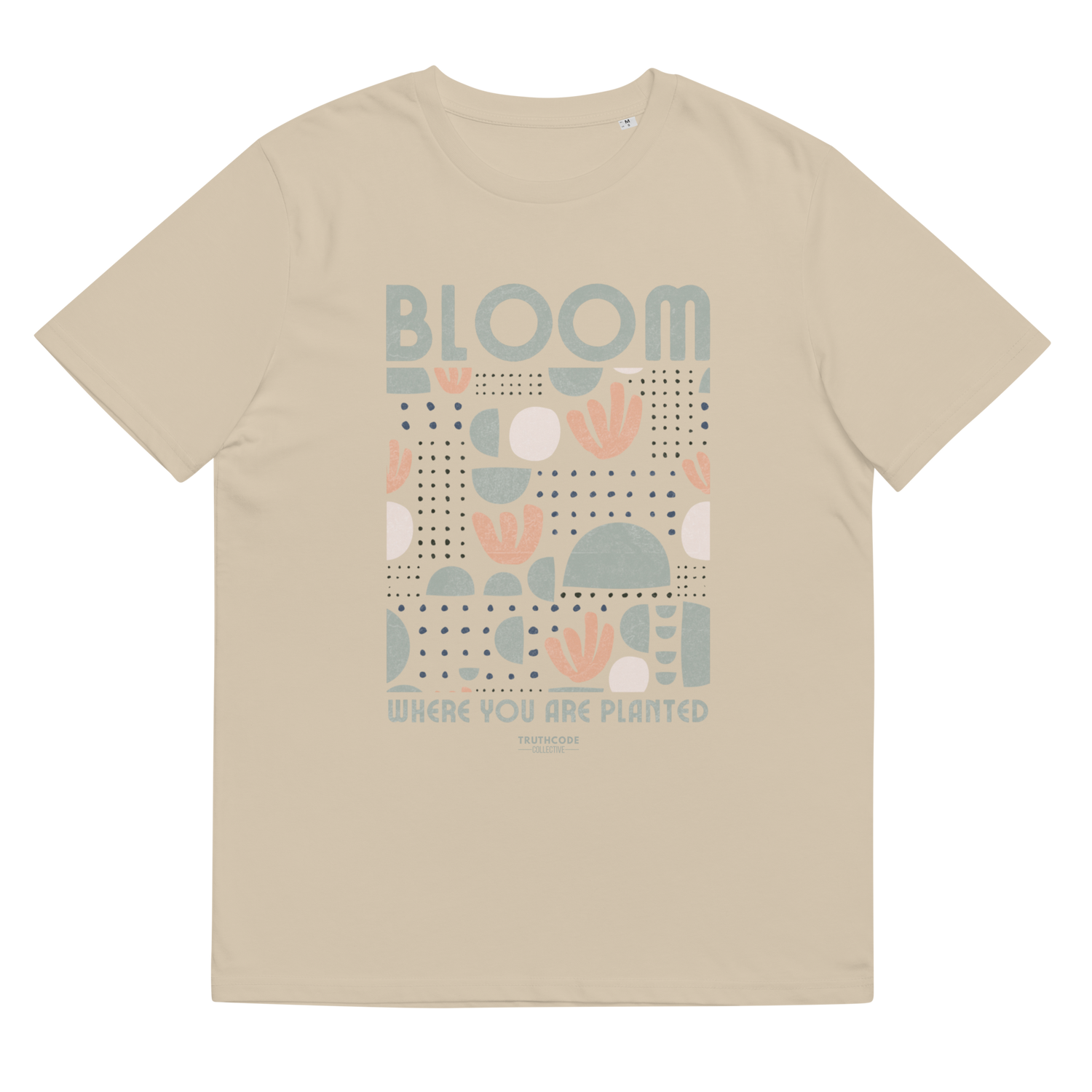Beige organic t-shirt with 'Bloom Where You Are Planted' text and graphic design on a white background