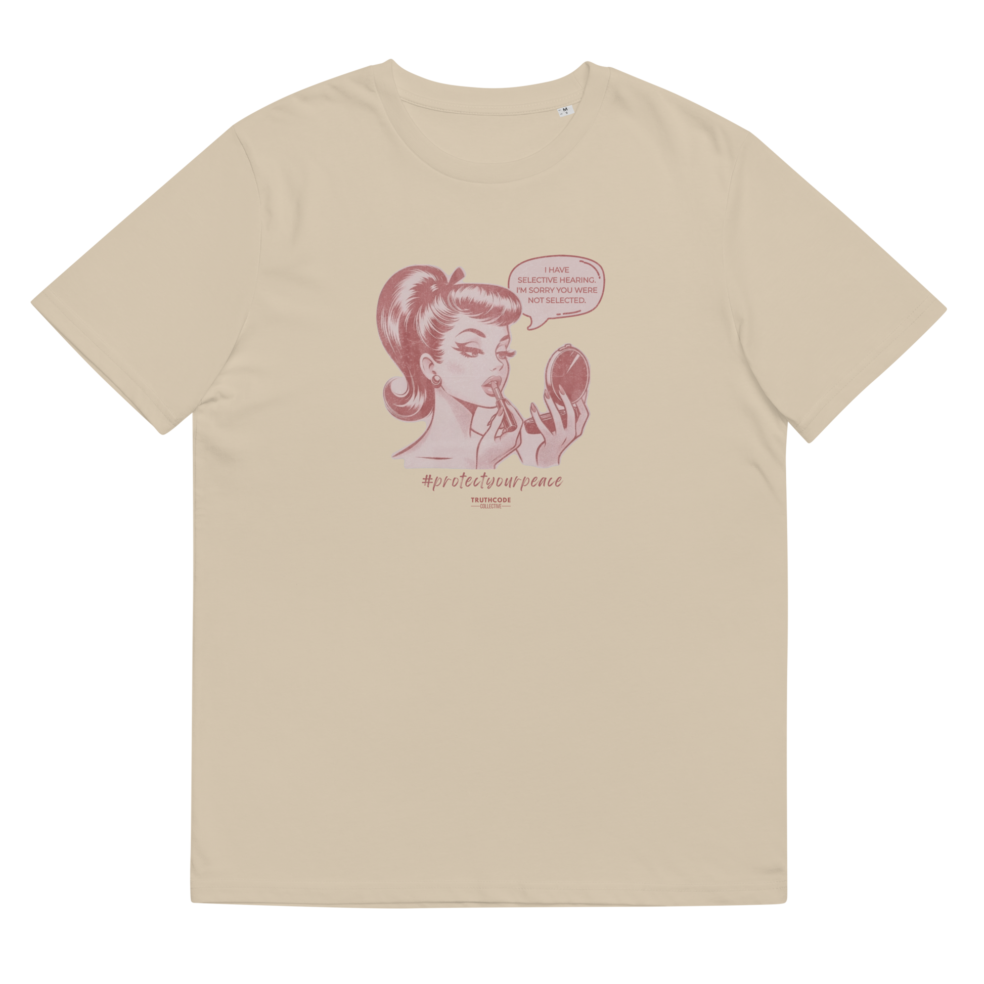 Beige organic t-shirt with a vintage style graphic of a woman looking at herself in a mirror and the text 'I have selective hearing. I'm sorry your were not selected', shirt on a white background