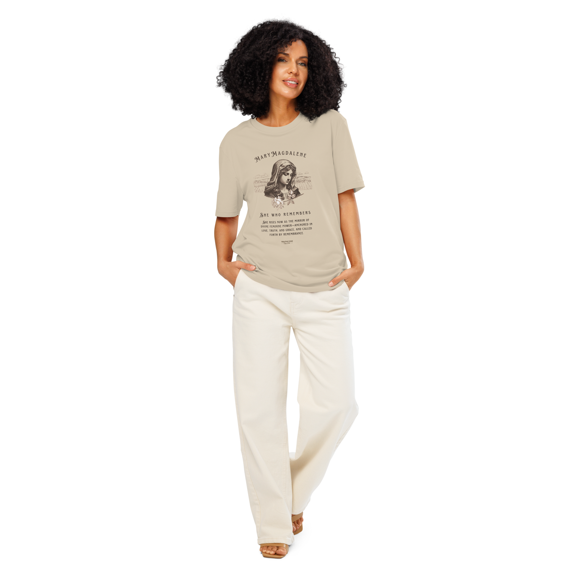 Woman wearing beige organic t-shirt with a graphic of Mary Magdalene and text 'She who remembers, she rises now as the mirror of the divine feminine power...',  on a white background