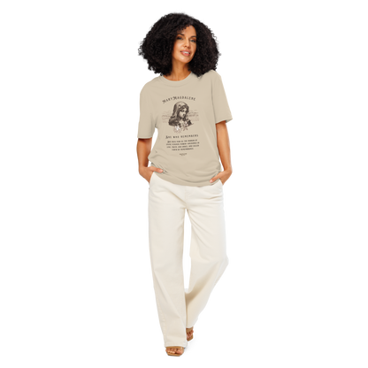 Woman wearing beige organic t-shirt with a graphic of Mary Magdalene and text 'She who remembers, she rises now as the mirror of the divine feminine power...',  on a white background