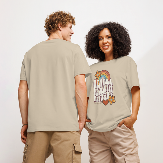 Models wearing beige organic t-shirt with 'Mental Health Matters' graphic design featuring a rainbow and flowers 