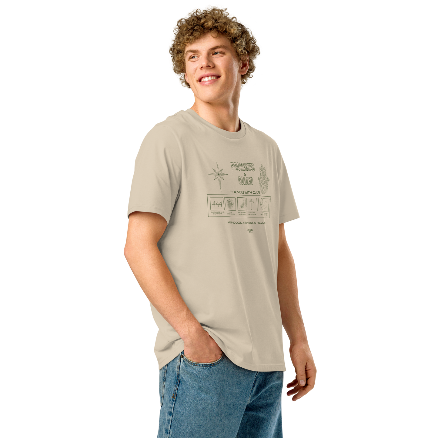 Guy wearing beige organic t-shirt with 'Protected + Guided' text and laundry tag style graphic design with elements relating to protection on a white background