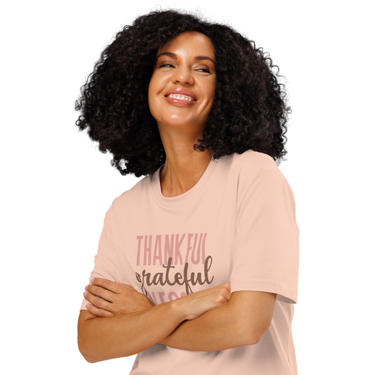 Woman wearing peach organic t-shirt with 'Thankful grateful BLESSED' text design on a white background