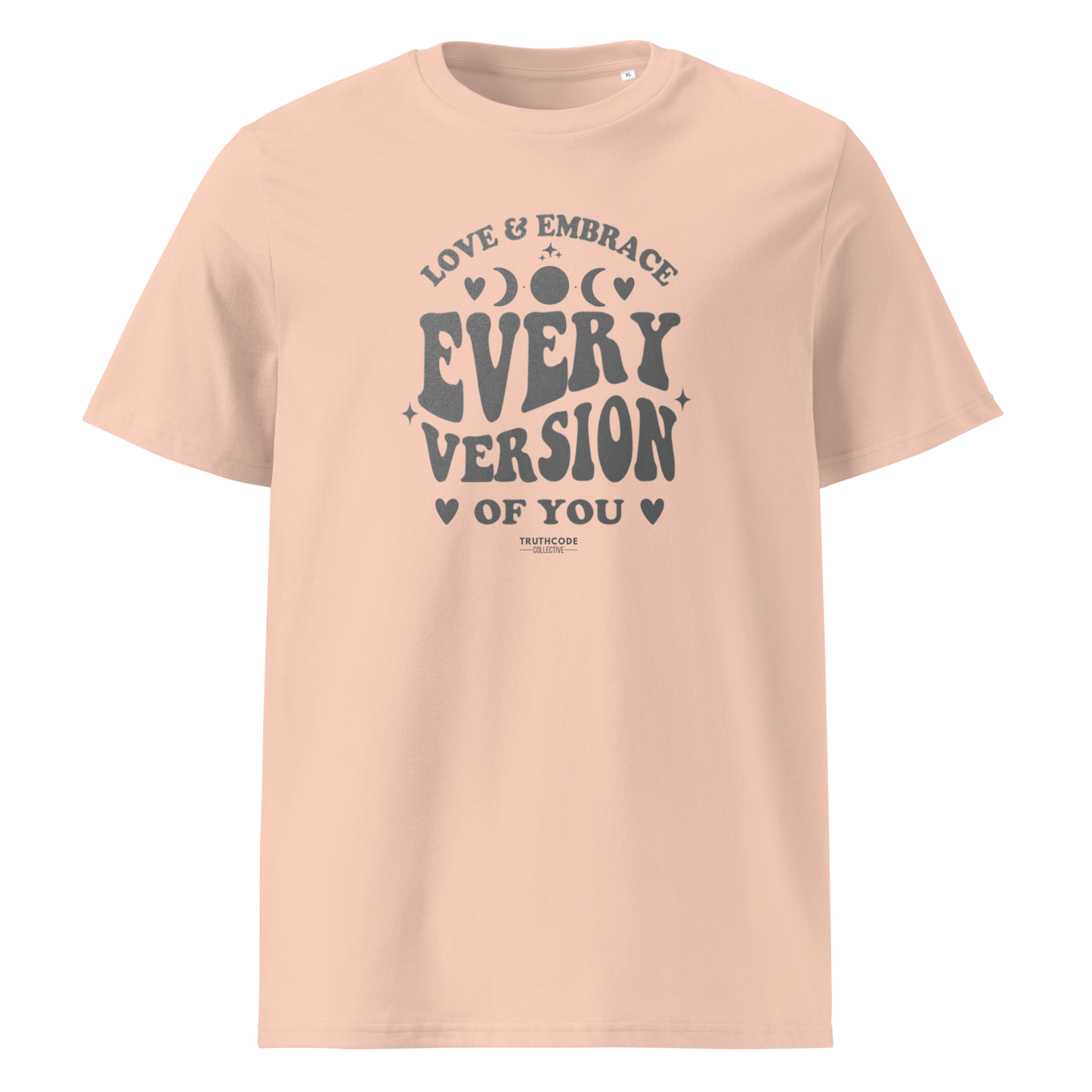 Peach organic t-shirt with motivational text 'Love & embrace every version of you' on a white background