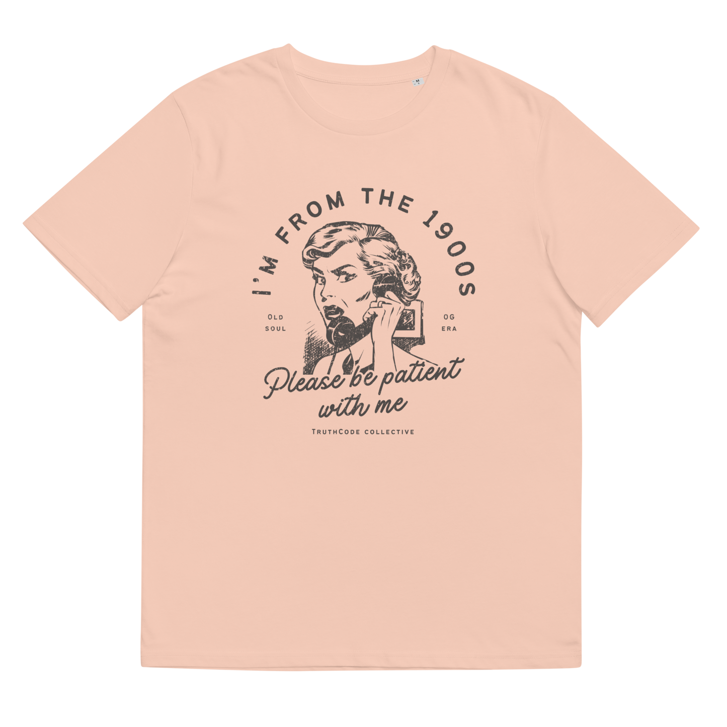 Peach organic t-shirt with vintage style graphic design of woman on the phone and text 'I'm from the 1900's, please be patient with me' on a white background