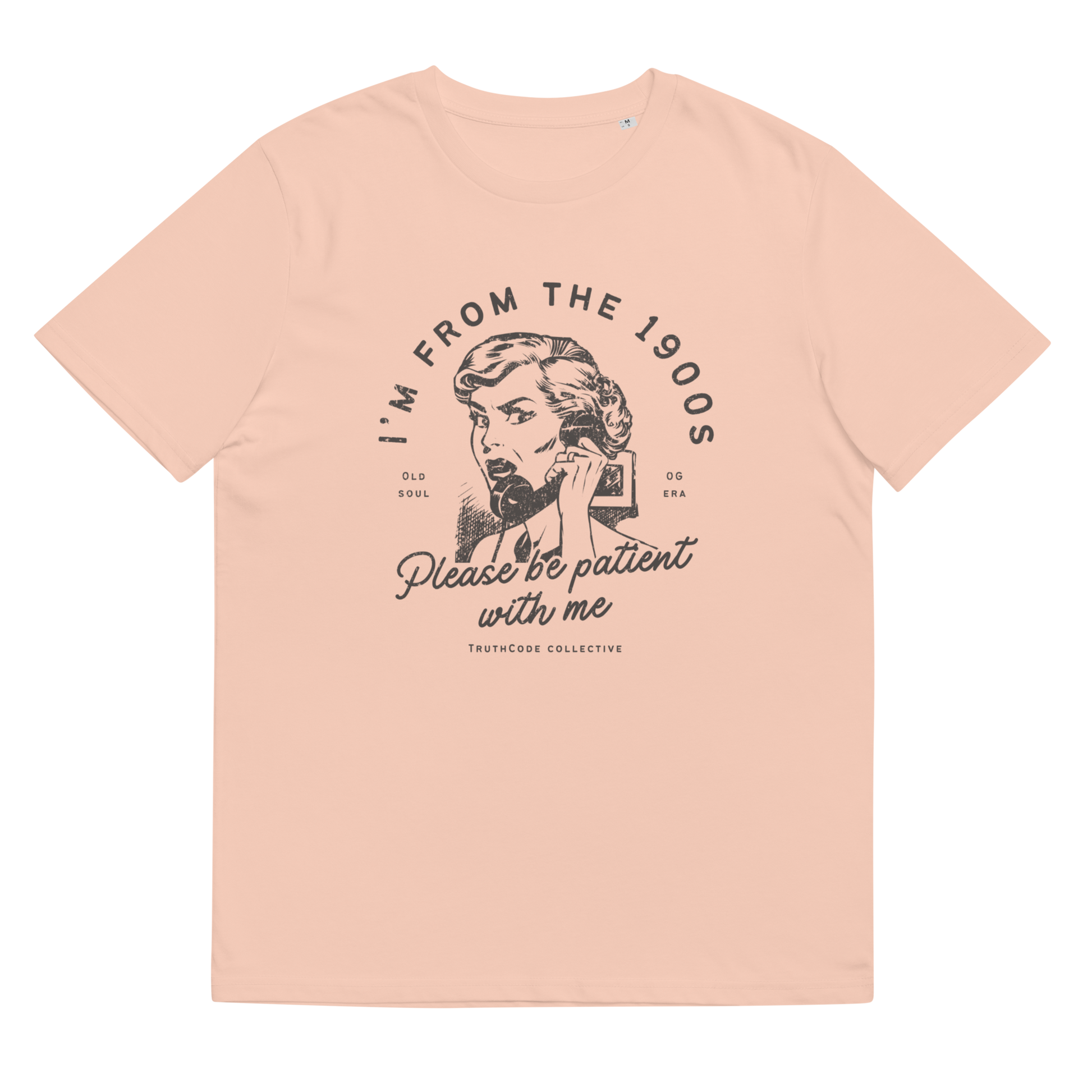 Peach organic t-shirt with vintage style graphic design of woman on the phone and text 'I'm from the 1900's, please be patient with me' on a white background