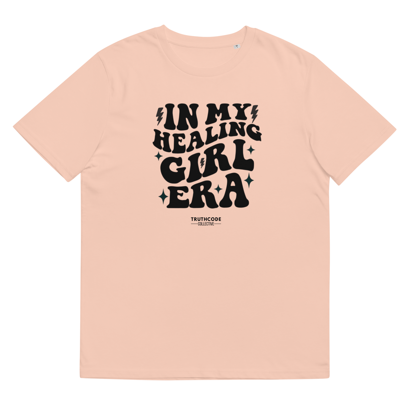 Peach organic t-shirt with black text 'IN MY HEALING GIRL ERA' on a white background
