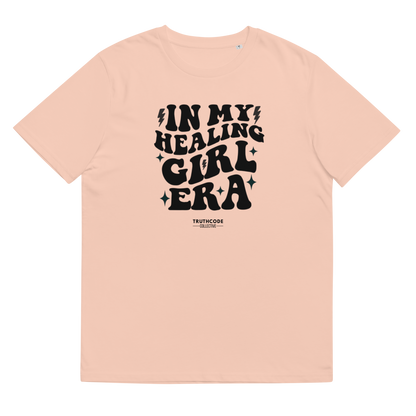 Peach organic t-shirt with black text 'IN MY HEALING GIRL ERA' on a white background