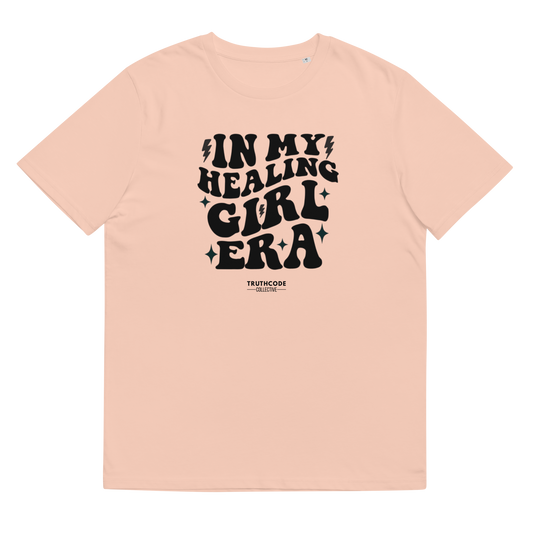 Peach organic t-shirt with black text 'IN MY HEALING GIRL ERA' on a white background