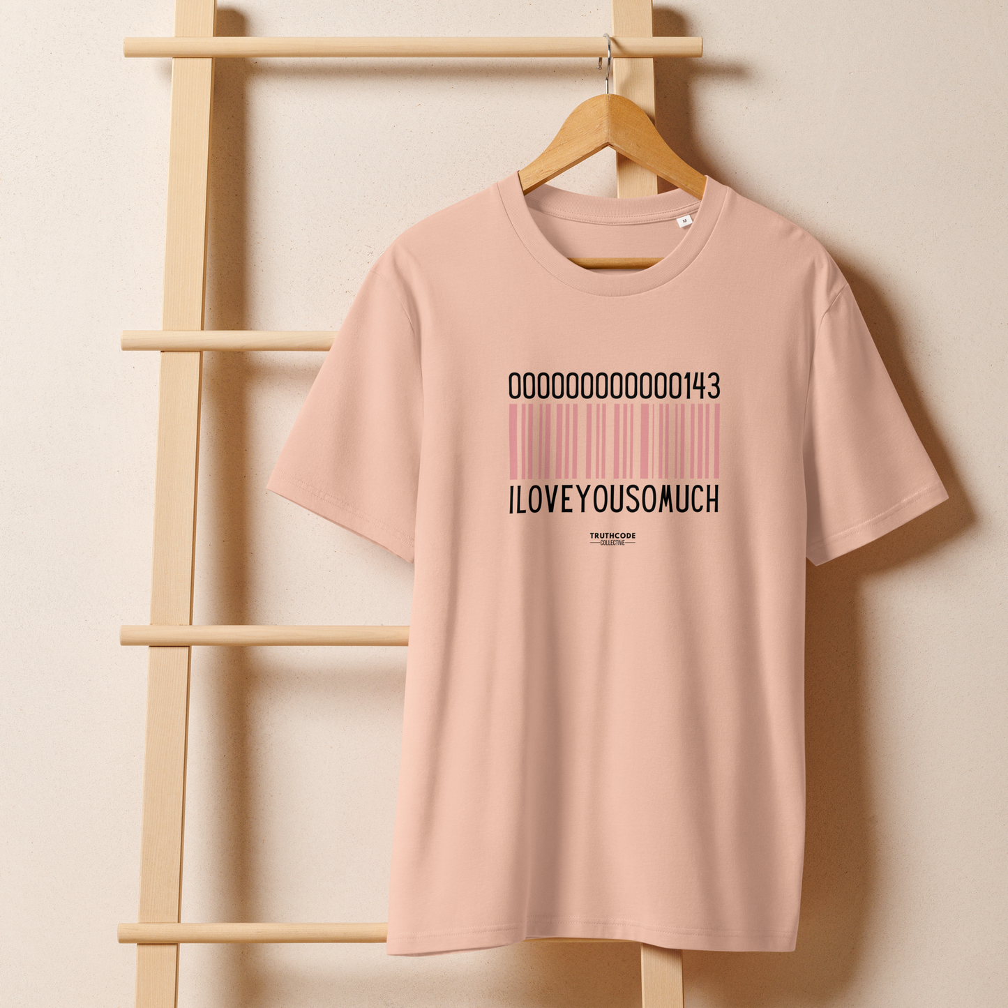 Peach organic t-shirt with a barcode design and numbers 143, with text 'I love you so much' on a hanger with a beige wall background