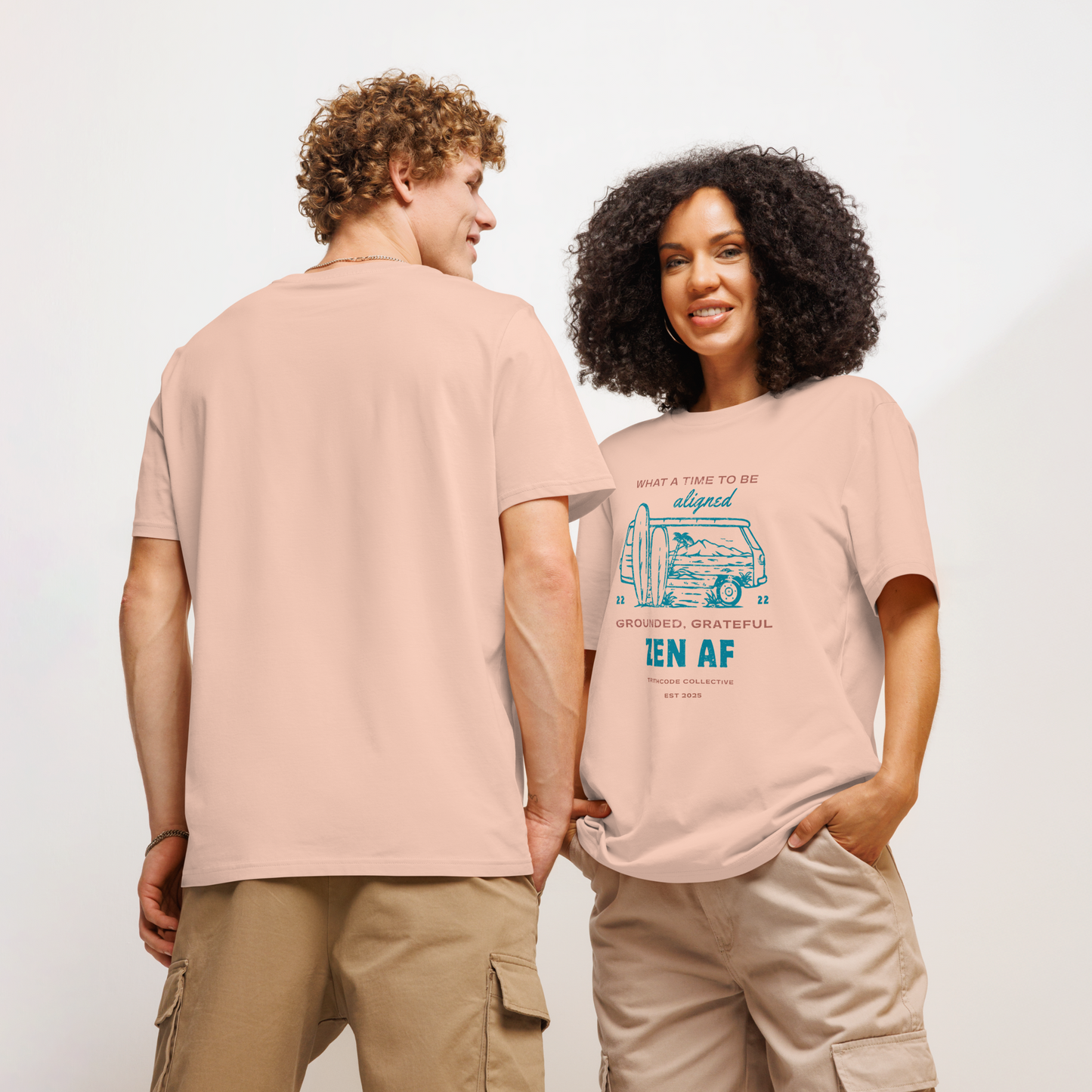 Models wearing peach organic t-shirt with a graphic design  of vintage surf van and text 'What a time to be aligned, grounded, grateful, zen AF' on a white background