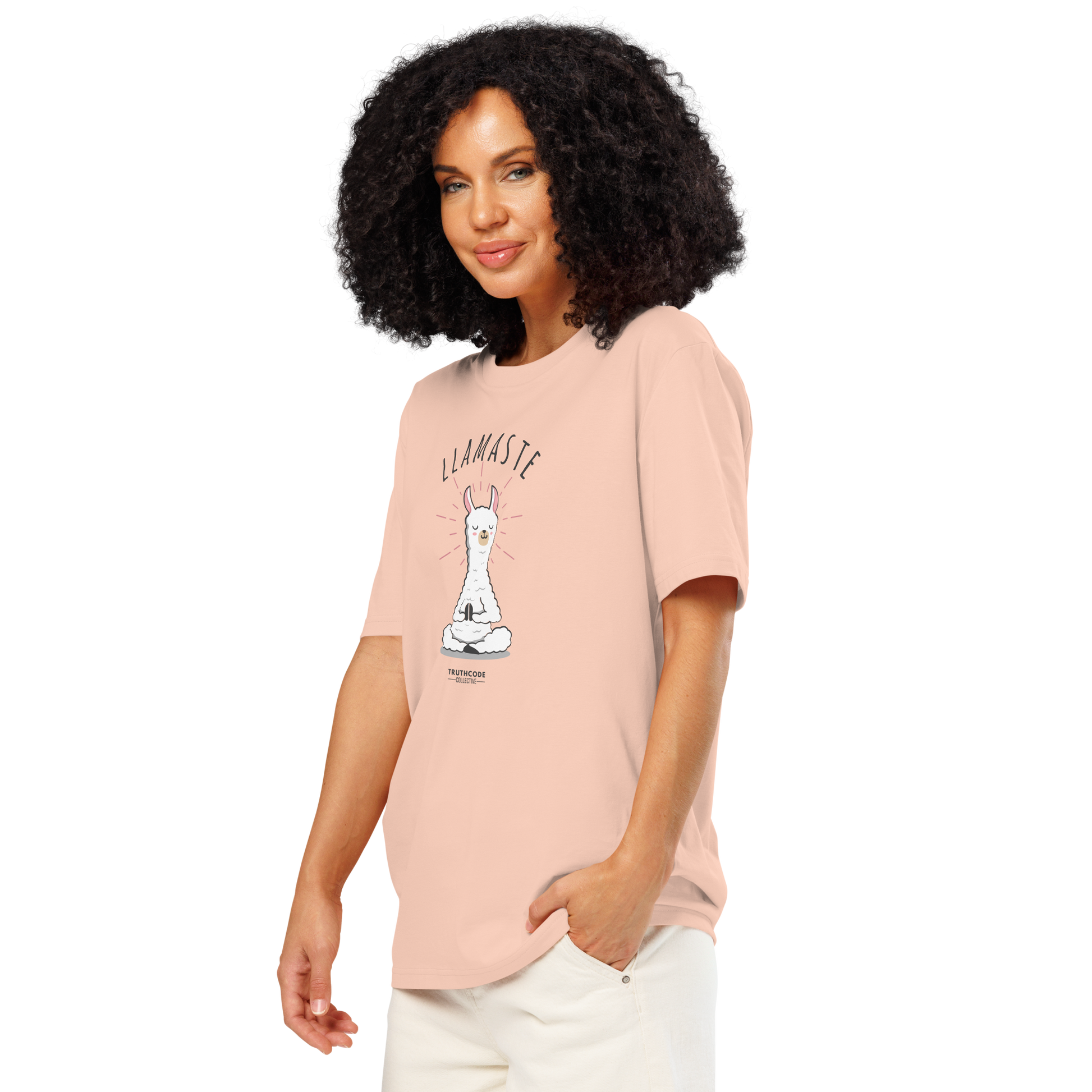 Woman wearing a peach organic t-shirt with a llama graphic in meditative pose and 'LLAMASTE' text on a white background