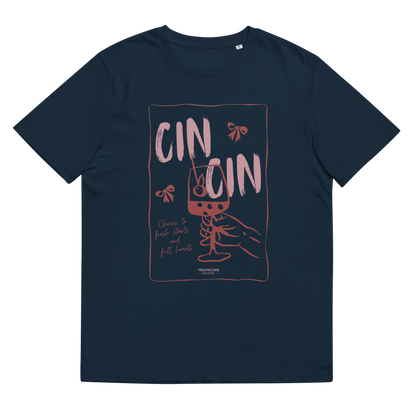 Navy blue organic t-shirt with text 'Cin Cin, cheers to fresh starts and full hearts' graphic design  of a glass, on a white background