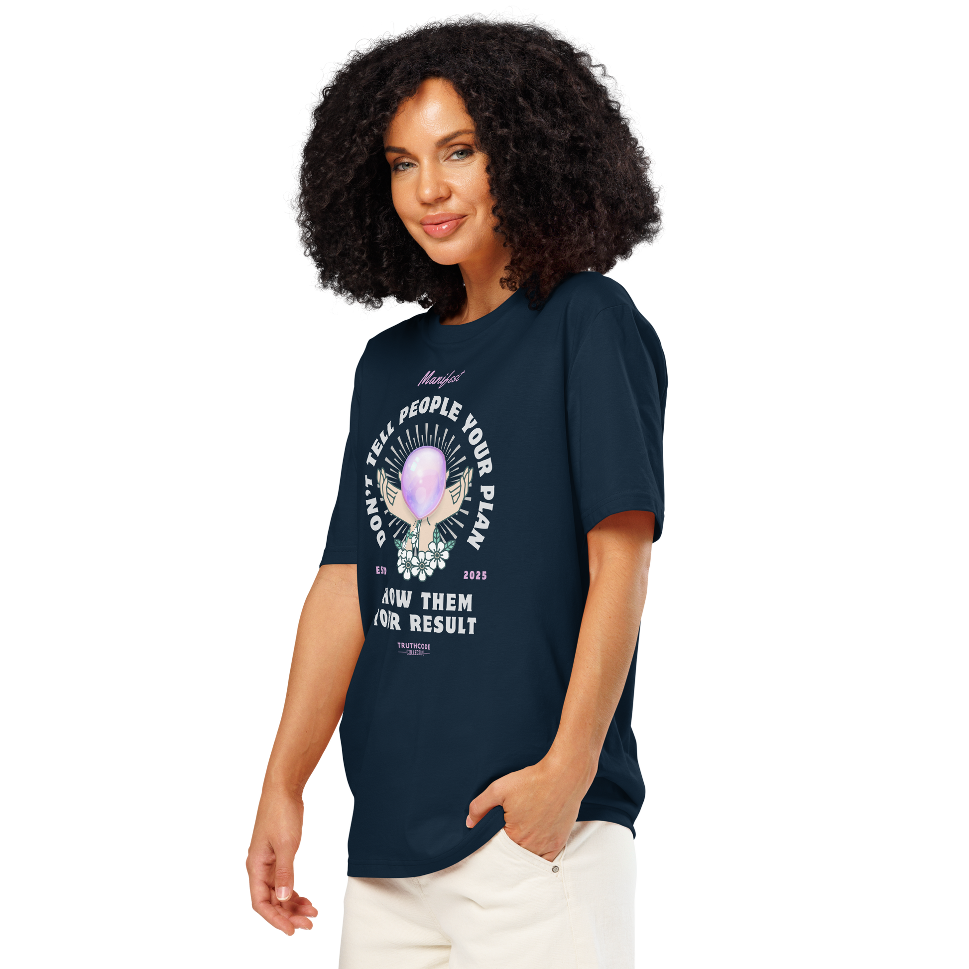 Woman wearing navy blue organic t-shirt with graphic design of hands holding a magic ball  and text 'Don't tell people your plan, show them your result' on a white background