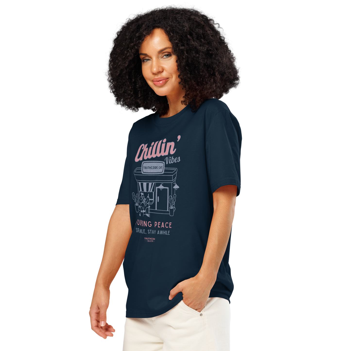 Woman wearing navy blue organic t-shirt with 'Chillin' Vibes, TruthCode Cafe' and 'Pouring peace, sip, smile, stay a while' graphic design on a white background