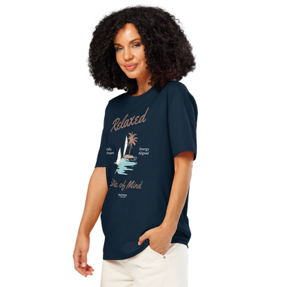 Woman wearing navy blue organic t-shirt with a sailboat graphic and text 'Relaxed state of mind', on a white background