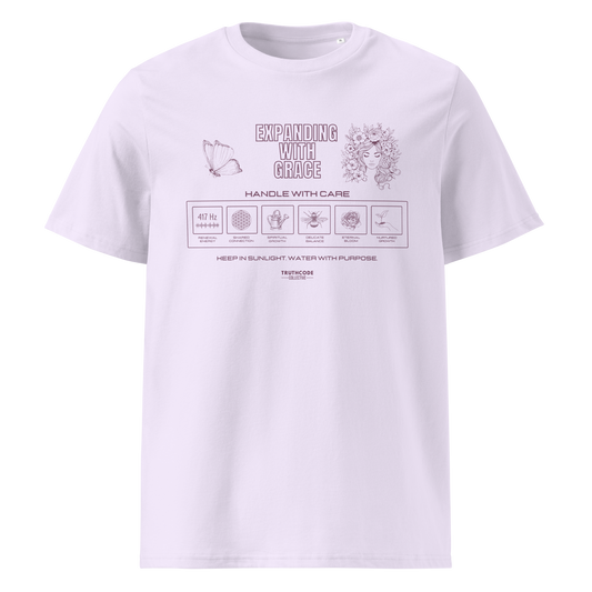 Lavender organic t-shirt with text 'Expanding with grace' with symbols and graphics relating to it on a white background