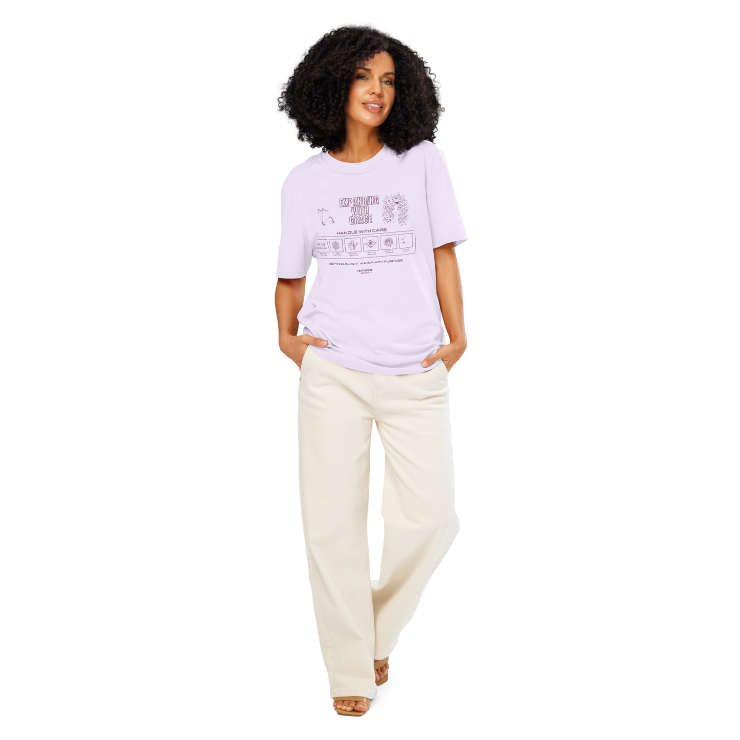 Woman wearing lavender organic t-shirt with text 'Expanding with grace' with symbols and graphics related to it on a white background