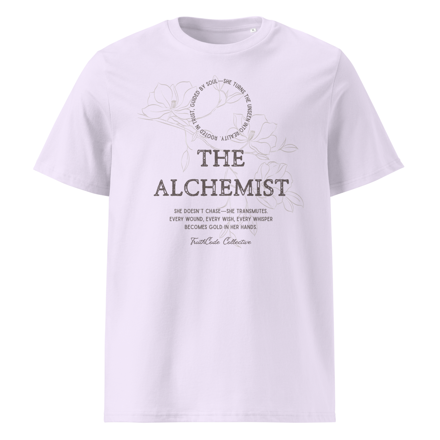 Lavender organic t-shirt with 'The Alchemist- she doesn't chase she transmutes. Every wound, every wish, every whisper becomes gold in her hands' text and soft floral design on a white background