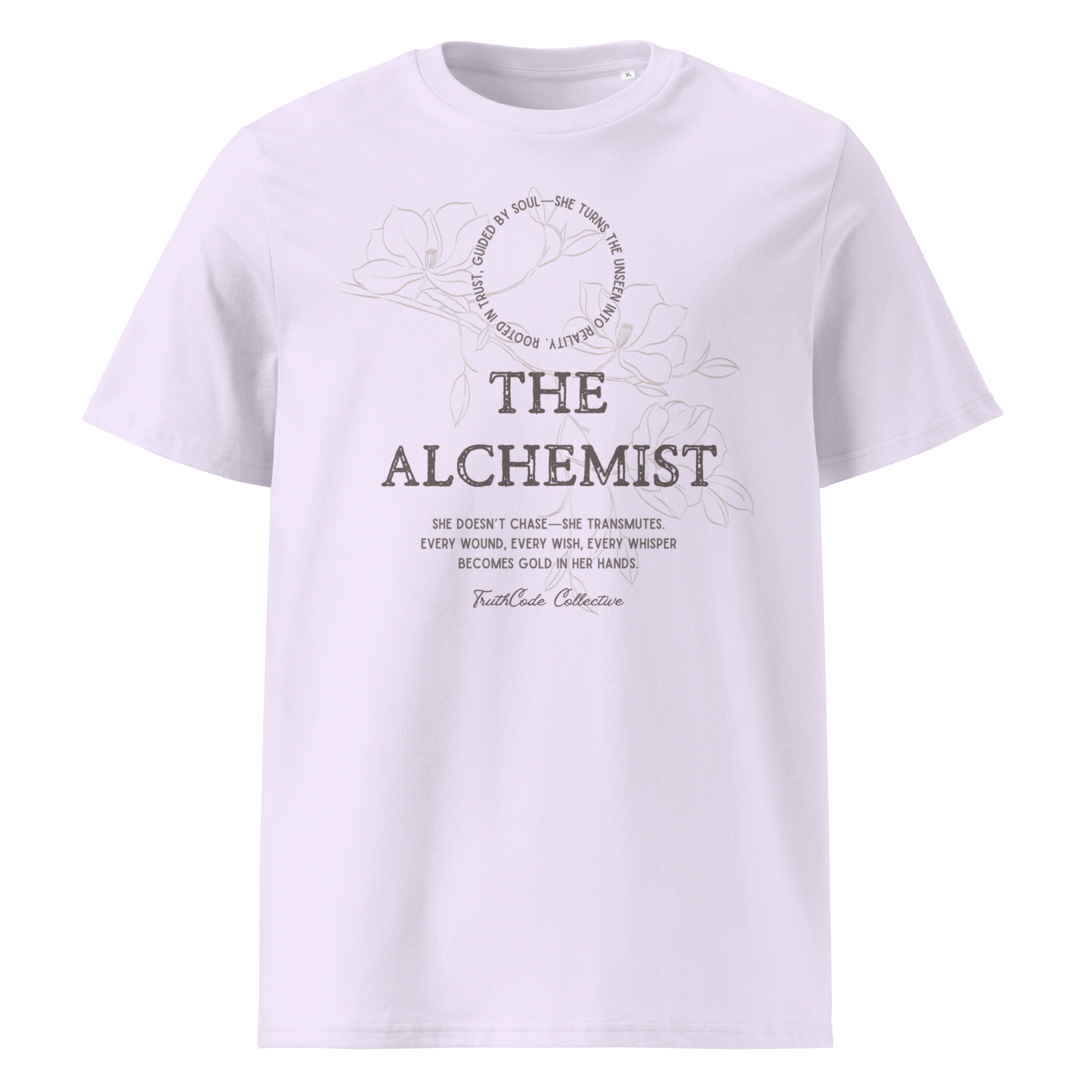 Lavender organic t-shirt with 'The Alchemist- she doesn't chase she transmutes. Every wound, every wish, every whisper becomes gold in her hands' text and soft floral design on a white background