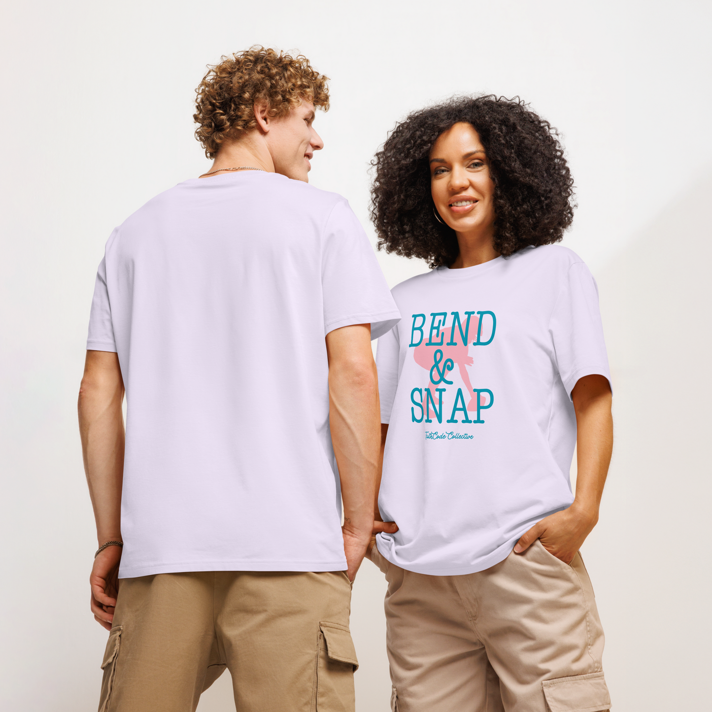 Models wearing lavender be organic t-shirt with 'Bend & Snap' text and football player snapping football silhouette graphic on a white background