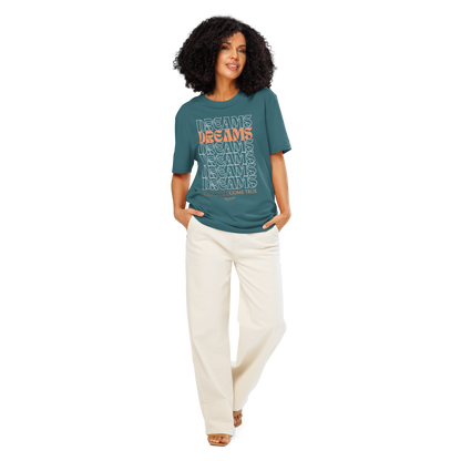Woman wearing teal organic t-shirt with 'Dreams Come True' text design, shirt on a white background