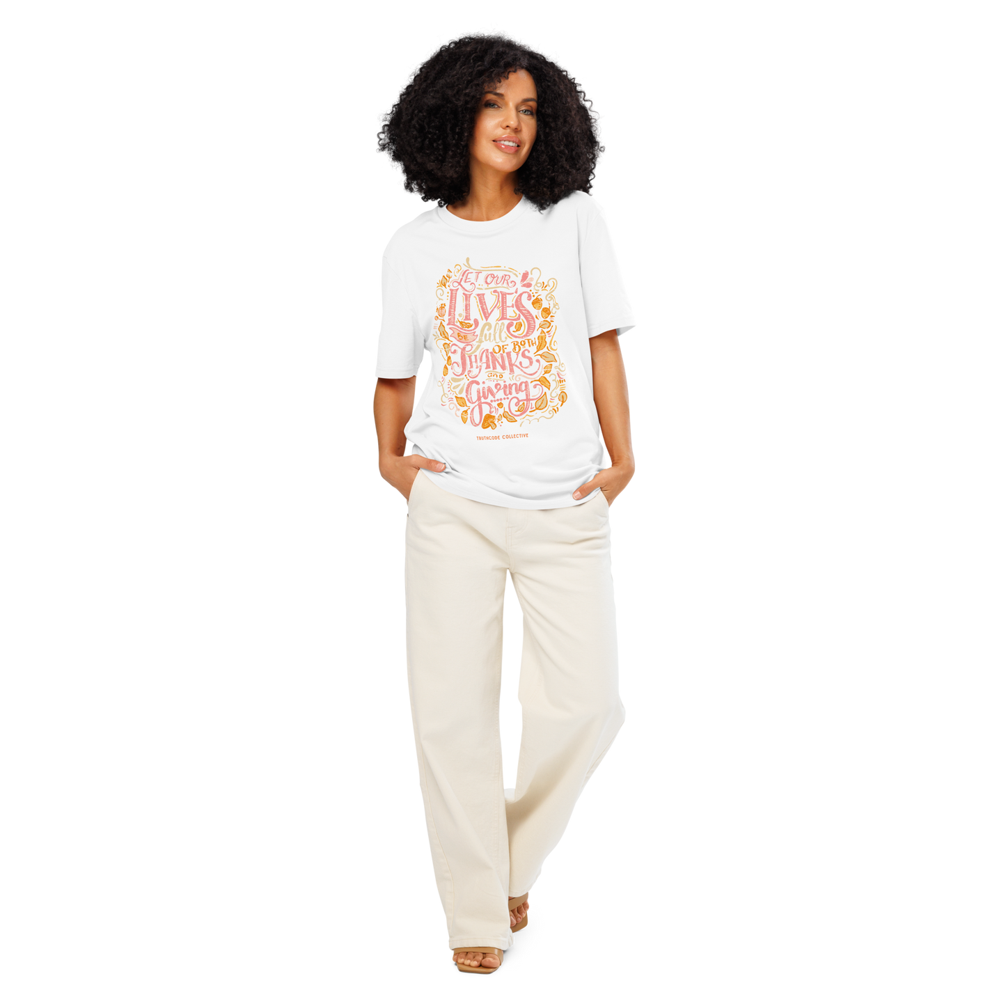 Woman wearing white organic t-shirt with colorful text design 'Let our lives be full of both thanks and giving' on a white background
