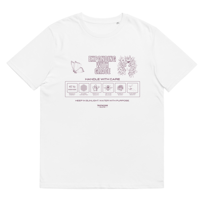 White organic t-shirt with text 'Expanding with grace'  and symbols relating to expanding in laundry tag style graphics on a white background