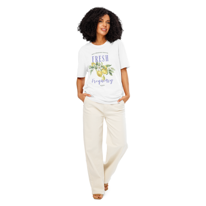 Woman wearing white organic t-shirt with lemon graphic and text 'Fresh frequency' on a white background