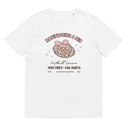 White organic t-shirt with girly football graphic design and text 'Manifesting a win, high vibes and hail marys' on a white background