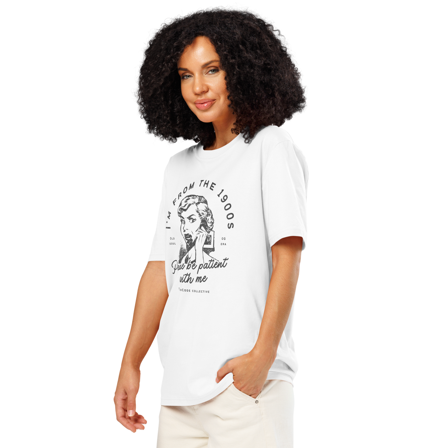 Woman wearing white organic t-shirt with vintage style graphic design of woman on the phone and text 'I'm from the 1900's, please be patient with me' on a white background