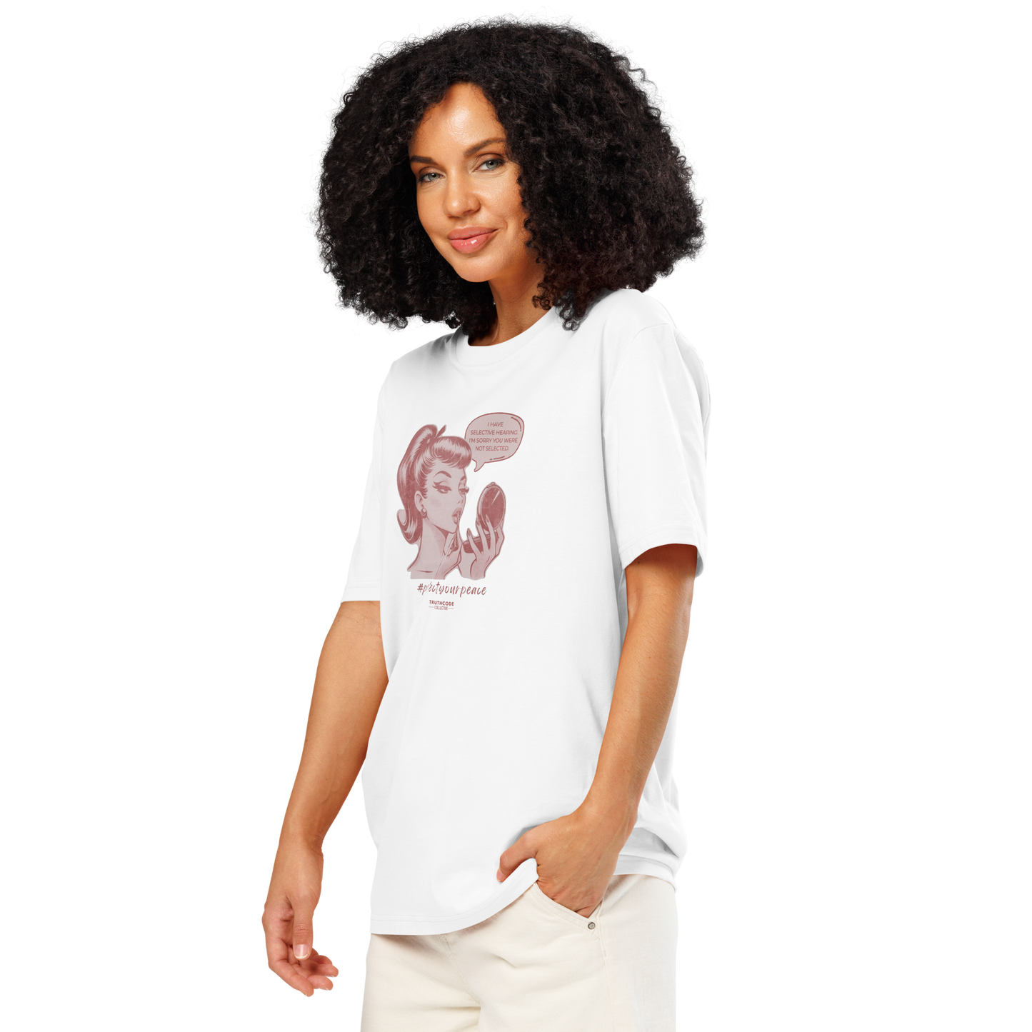 Woman wearing white organic t-shirt with a vintage style graphic of a woman looking at herself in a mirror and the text 'I have selective hearing. I'm sorry your were not selected', on a white background