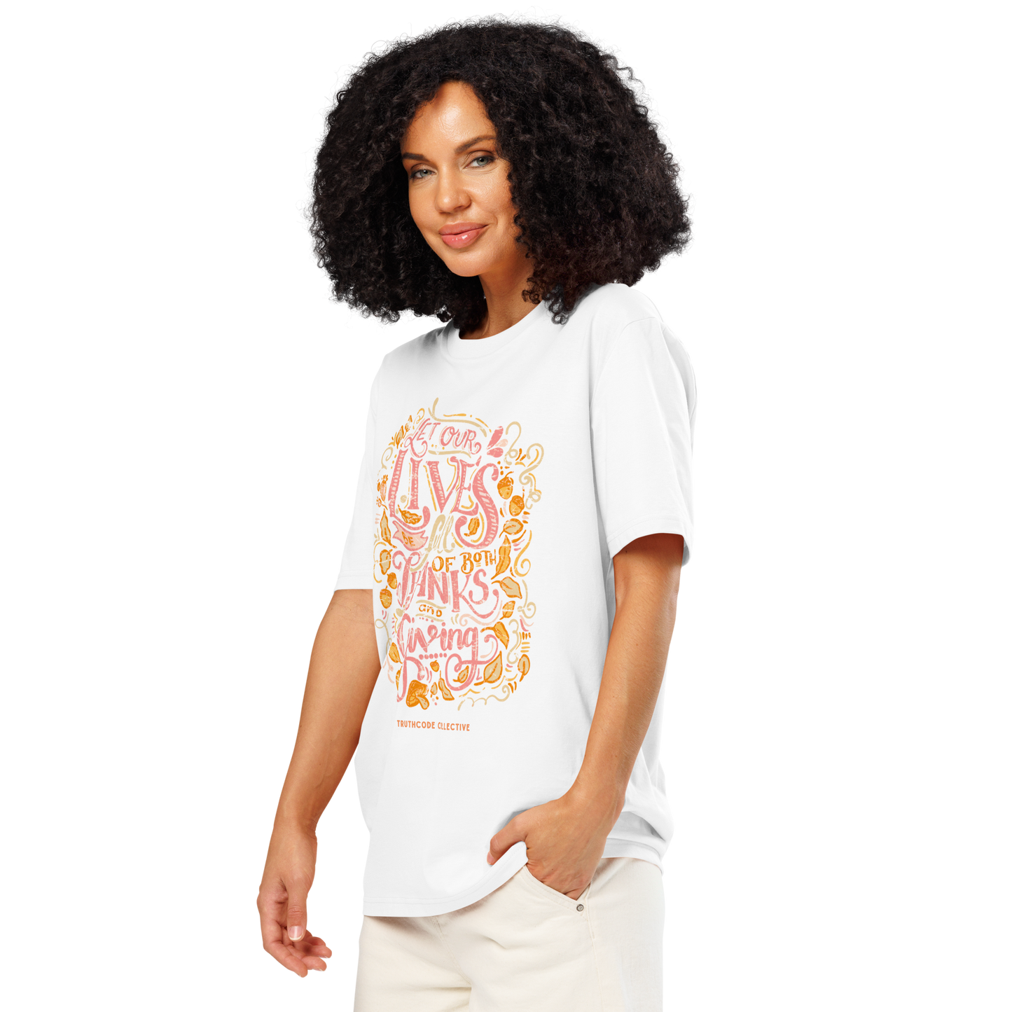 Woman wearing white organic t-shirt with colorful text design 'Let our lives be full of both thanks and giving' on a white background