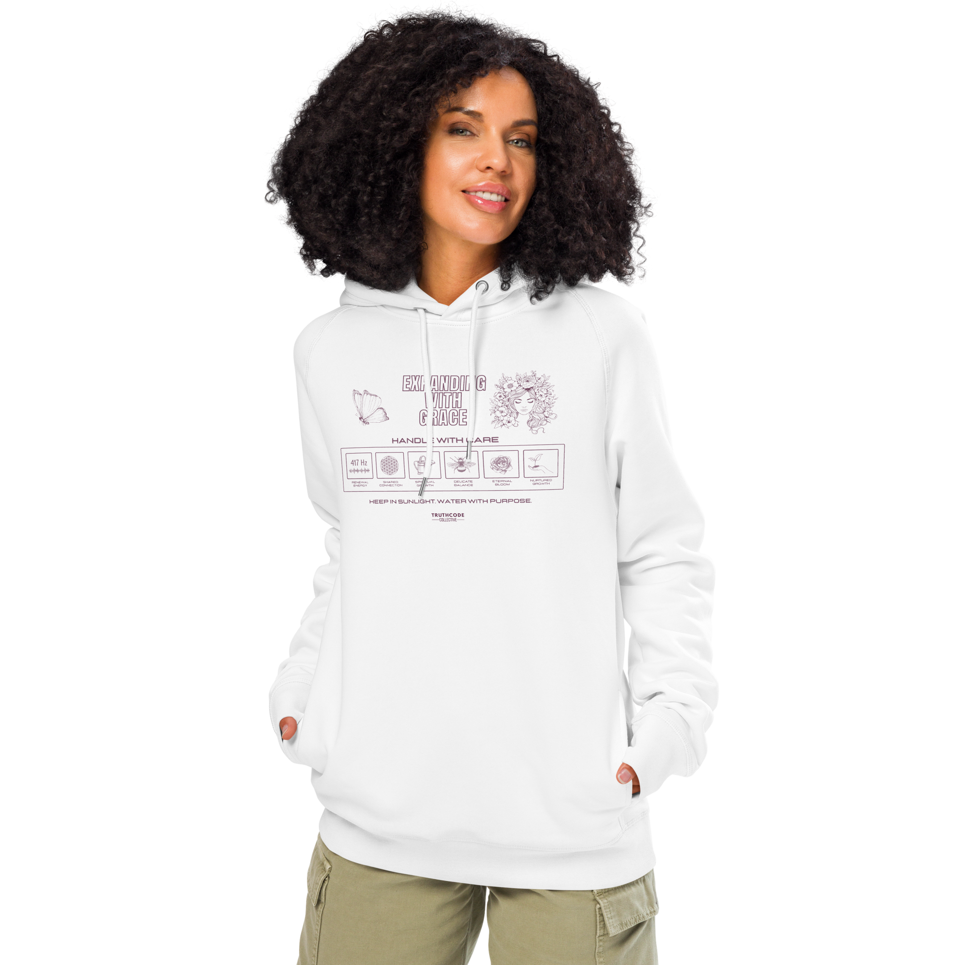Woman wearing white organic hoodie with text 'Expanding with grace' with symbols and graphics relating to it on white background