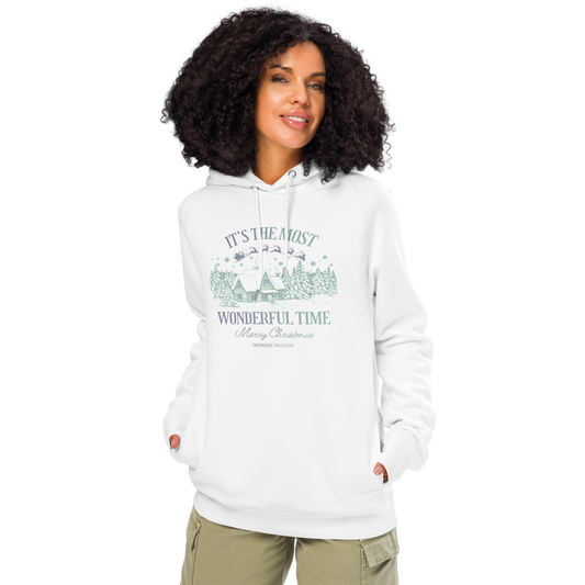 Woman wearing white organic hoodie with Christmas-themed design and text 'It's the most wonderful time of the year' on a white background
