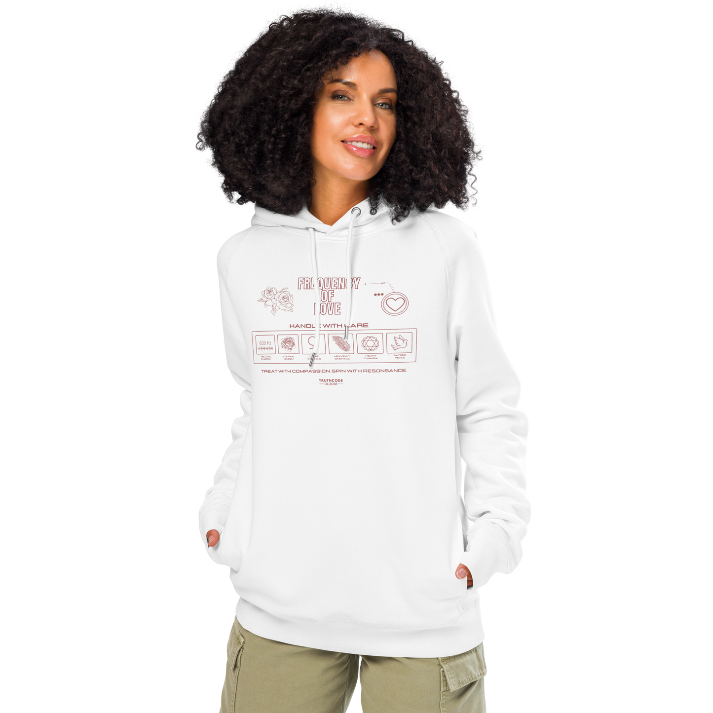 Woman wearing white organic hoodie with graphic design like a laundry tag and text 'Frequency of love' on a white background