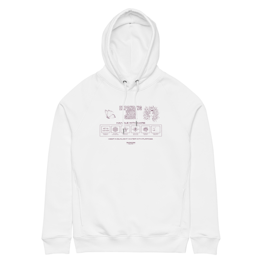 White organic hoodie with graphic design like a laundry tag and text 'Expanding with grace' on a white background
