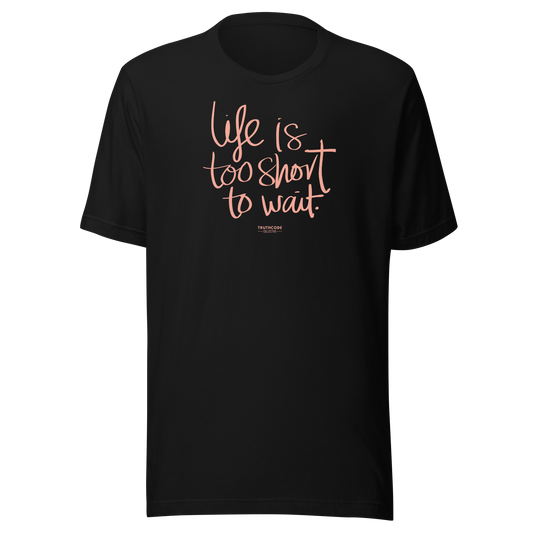 Black t-shirt with pink text 'Life is too short to wait' on a white background